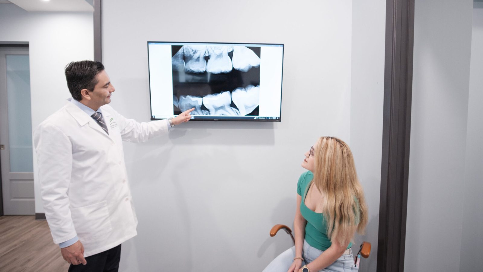 Patient receiving dental education from Dr. Alexander Ochoa